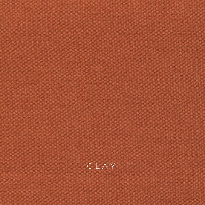 Clay organic cotton canvas is a sun baked orange color and has a coarse texture. The fabric is made from organic cotton fibers that are woven together in a plain weave. The fabric is durable, breathable and eco-friendly.