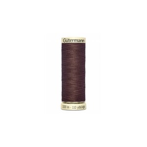 May include: A spool of dark brown Gutermann thread with a label that reads "Gutermann" and "100 m - 110 yds/vgs".