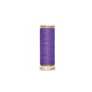 May include: A spool of Gütermann thread in a purple color. The spool is labeled with "100 m - 110 yds/vgs".