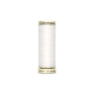 May include: A white spool of Gütermann thread with a label that reads "Gütermann" and "100 m - 110 yds/vgs".