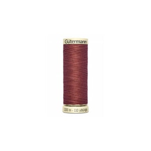 May include: A spool of maroon thread with the brand name "Gütermann" printed on the label. The spool is 100 meters long, or 110 yards.