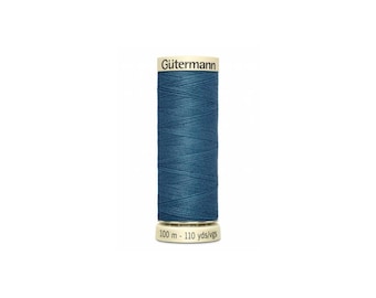 May include: A spool of Gütermann thread in a deep blue color. The spool is labeled with the brand name and the length of the thread: 100 m - 110 yds/vgs.