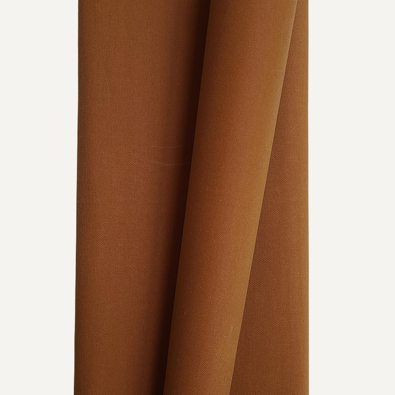 Whiskey Brown waxed canvas folded on white background