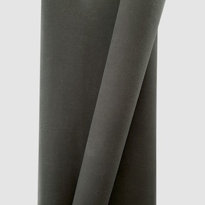 May include: Two rolls of dark gray fabric, folded and stacked on top of each other.