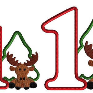 May include: Red number one with a green Christmas tree and a brown moose inside. The moose is sitting in the tree with its legs crossed.