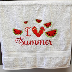 May include: White bath towel with red embroidery that says "I love summer" with a red heart and watermelon slices around the text.