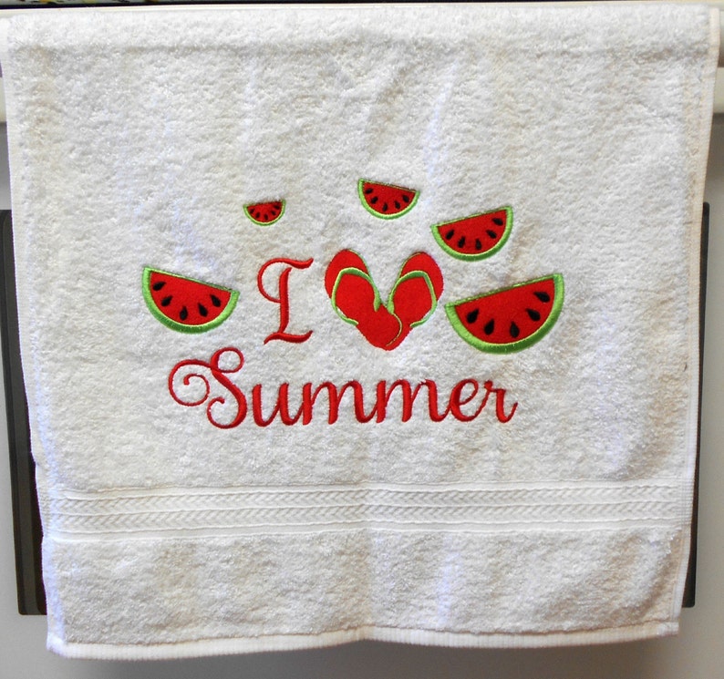 May include: White bath towel with red embroidery that says "I love summer" with a red heart and watermelon slices around the text.