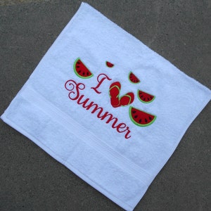 May include: White beach towel with red embroidery that says "I Love Summer" with a heart shape made of red flip flops and watermelon slices around the text.