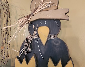 Handmade wooden crow with raffia