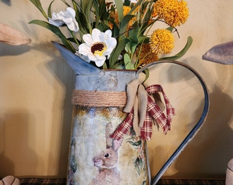 White daisies and craspedia flowers in an large pitcher