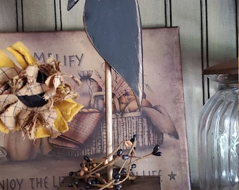 Wooden crow on dowel rod with berries and rusty star