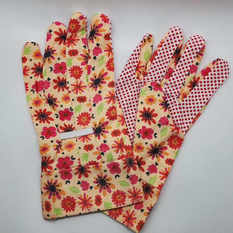 May include: A pair of gardening gloves with a floral print on the back and a red polka dot pattern on the palm side. The gloves are made of a soft, breathable fabric and are designed for comfort and durability.