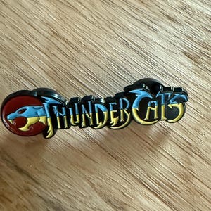Thundercats Logo Enamel Pin – Retro Cartoon Collectible, 80s Kid Gift, Fandom Pin, Nerd Culture Must-Have