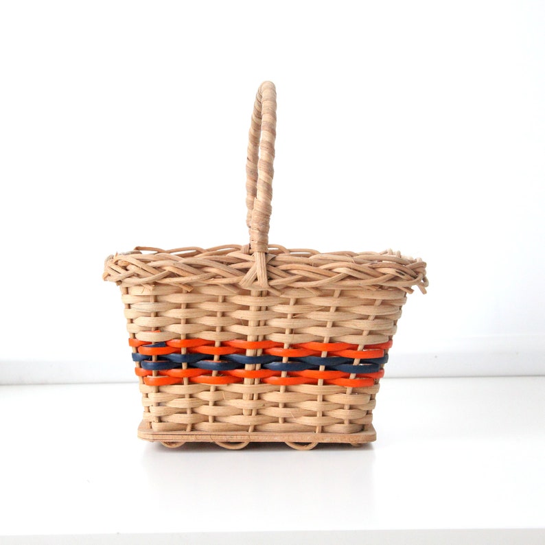 Vintage 1970s small shopping wicker or ratan basket with orange and blue accents