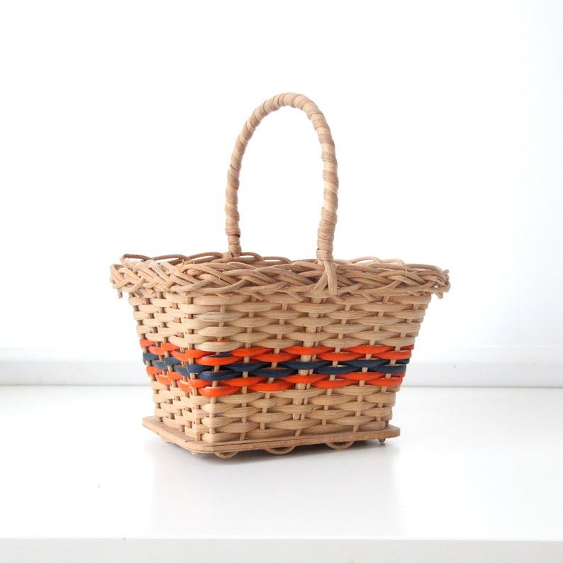 Vintage 1970s small shopping wicker or ratan basket with orange and blue accents