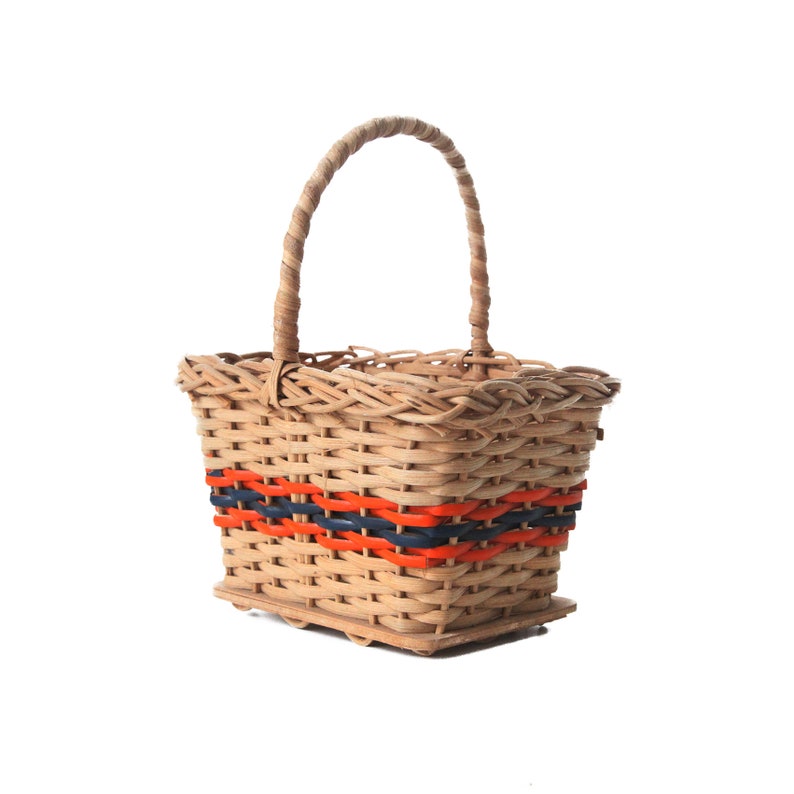 Vintage 1970s small shopping wicker or ratan basket with orange and blue accents