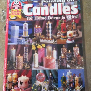 May include: A magazine cover titled "Painting on Candles for Home Decor & Gifts" featuring various decorated candles. The cover includes images of pillar candles with painted designs, and the Design Originals logo.