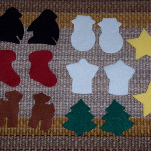 May include: A collection of felt Christmas ornaments in various shapes. Includes two black penguins, two white snowmen, two red stockings, two brown reindeer, two white shirts, two green Christmas trees, and two yellow stars. The ornaments are arranged on a textured, neutral-toned surface.