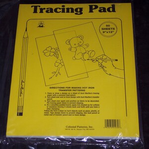 May include: Yellow tracing pad with the text "Tracing Pad" and "50 Sheets 9"x12". Includes instructions for hot iron transfer patterns. Features a pencil illustration and a drawing of a teddy bear and flowers.