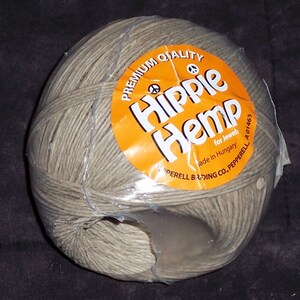 May include: A ball of gray hemp twine wrapped in clear plastic. The orange label reads "Hippie Hemp" with the text "for Jewel" and "Made in Hungary". The twine is for jewelry making.