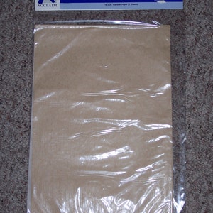 May include: A package of Acclaim brand transfer paper containing two sheets. The packaging features a blue header with the text TRANSFER PAPER and the Acclaim logo. The sheets are light brown and enclosed in a clear plastic sleeve.
