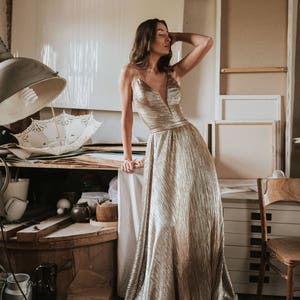 Shiny bodysuit with V-neck deep scoop. Metallic top good as wedding bodysuit or bridal separate. Evening bodysuit, formal bodysuit