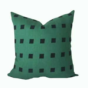 May include: A green pillow with a black square pattern.