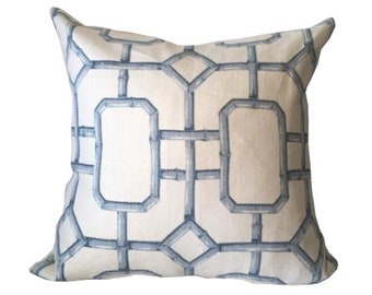 May include: A white throw pillow with a blue geometric pattern. The pattern resembles a lattice or trellis design.