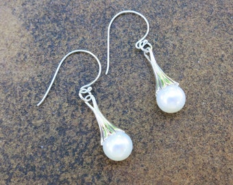 White pearls with sterling silver cones and ear wires.