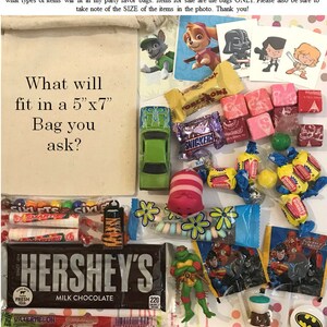 Puede incluir: Una variedad de peque&ntilde;os juguetes y dulces, incluyendo un coche de juguete verde, un juguete de peluche rosa y blanco, una barra de chocolate y varias bolsas de dulces. El texto "What will fit in a 5"x7" Bag you ask?" est&aacute; escrito en un papel.