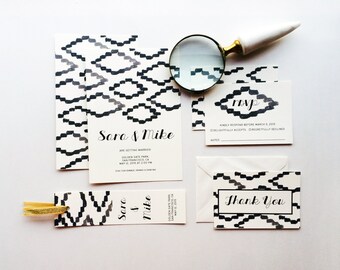 May include: A set of wedding stationery with a black and white geometric design. The collection includes invitations, RSVP cards, and thank you cards. The invitation reads "Sara & Mike" and includes event details.
