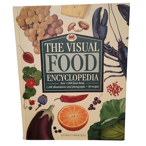 May include: The cover of a book titled "The Visual Food Encyclopedia" with illustrations of various fruits, vegetables, and seafood. The book features over 1,000 food items, 1,200 illustrations and photographs, and 90 recipes.