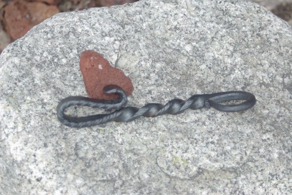 Hammer-finished, hand-forged iron bottle opener — you can literally see the blacksmith's work in every facet, and no two are identical.
