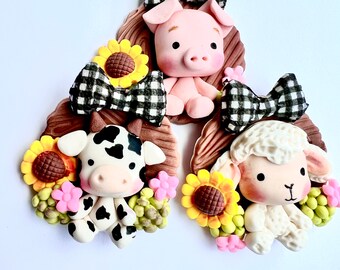 farm animal clay centers, black and white cow bow center, farm clays, pig clay, sheep clay