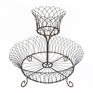 May include: A two-tiered wire fruit basket with a round bottom tier and a smaller, round top tier. The basket is made of metal wire and has a rustic, antique finish.