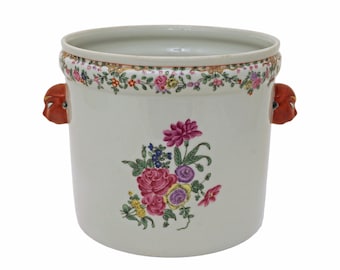 May include: White porcelain planter with floral design and red lion head handles.