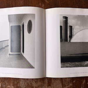 May include: A black and white photograph of a ship's deck with a door and porthole. The deck has a railing and a view of the water. The second image shows a ship with smokestacks and a curved roof.