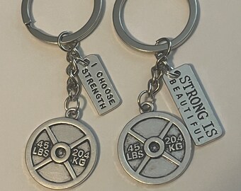 lot of 2 weightlifting key chains. “Strong is Beautiful” &  “I choose strength”.