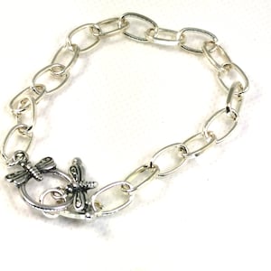 May include: Silver chain bracelet with a dragonfly clasp.