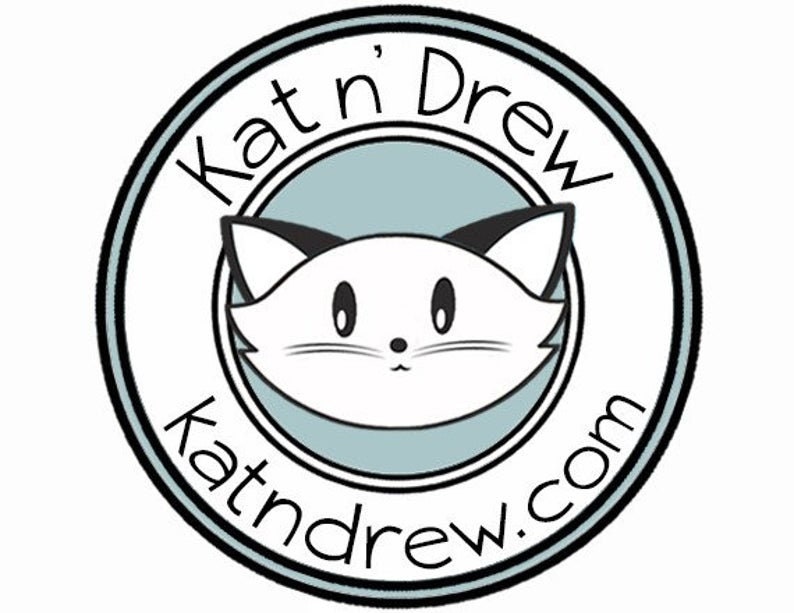 May include: Black and white logo with a stylized cat in a circle. The text "Kat 'n Drew katndrew.com" is around the circle.