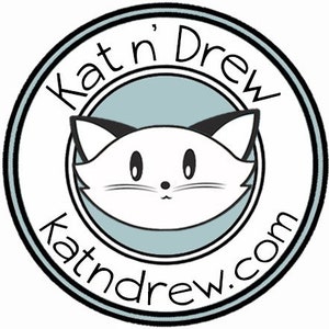 May include: Black and white illustration of a cat's face inside a circle with the text "Kat'n Drew katndrew.com" around the edge.