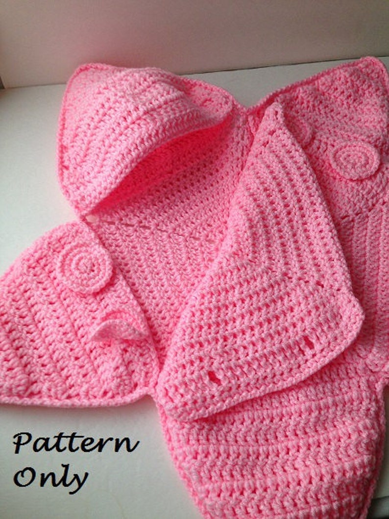 May include: Pink crocheted baby blanket with a hood and buttons. The blanket is made with a simple stitch and has a delicate, feminine look.  Pattern Only.