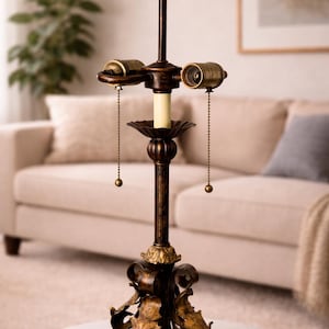 May include: A white ceramic mug with a black handle and the text "But First, Coffee" in a black, bold font. The mug is sitting on a wooden surface. The mug is approximately 4 inches tall.