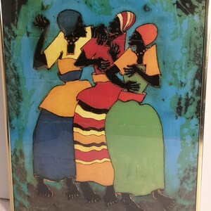 May include: A framed artwork depicting four figures in colorful clothing. The figures are rendered in black with yellow, red, green, and blue garments. The background is a mix of blue and green hues. The artwork is framed in a gold-colored metal frame.