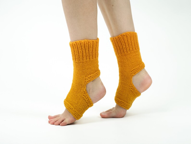 May include: A pair of mustard yellow knitted ankle socks with an opening at the heel. The socks are made of a soft, comfortable material and are perfect for yoga or Pilates.