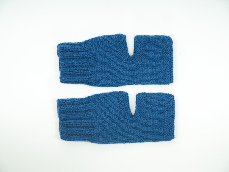 May include: A pair of blue fingerless knitted gloves. The gloves are made of a soft, warm material and have a fingerless design.
