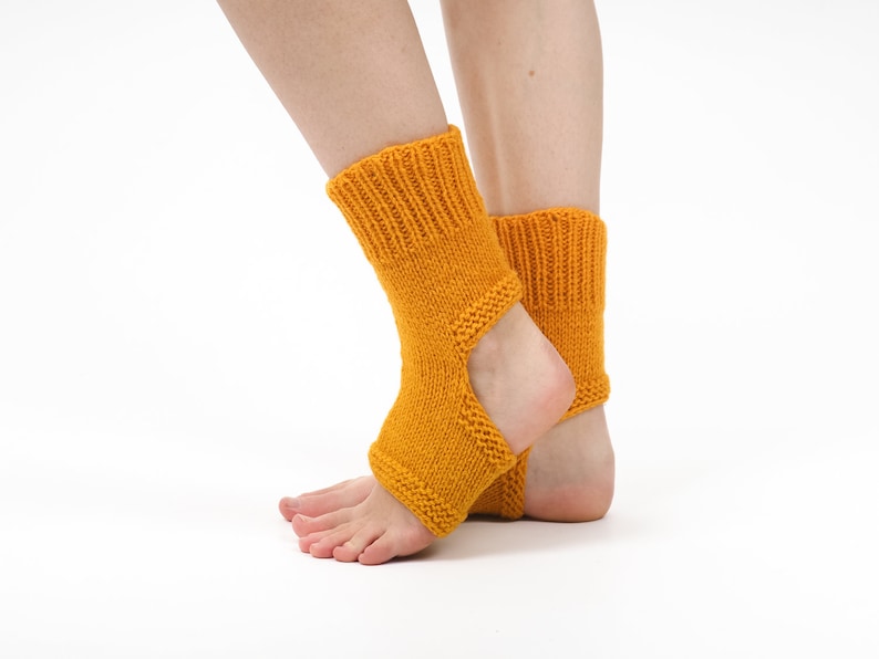 May include: A pair of yellow knitted ankle socks with an opening at the heel. The socks are made of a soft, warm material and are perfect for keeping your feet warm in the winter.