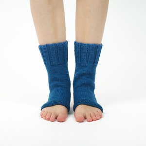 May include: A pair of blue knitted ankle socks with open toes. The socks are made of a soft, comfortable material and are perfect for wearing around the house or for yoga.