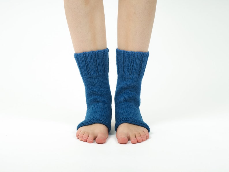 May include: A pair of blue knitted ankle socks with open toes. The socks are made of a soft, comfortable material and are perfect for wearing around the house or for yoga.
