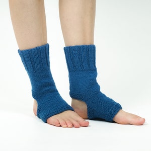 May include: A pair of blue knitted ankle warmers with an opening for the heel. The warmers are made of a soft, stretchy material and are perfect for keeping your feet warm in the winter.